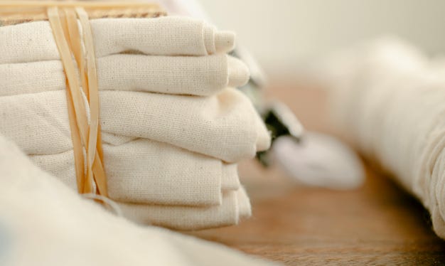 Stack of cleaned linens bundled up on countertop