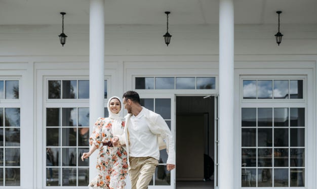 Couple in front of local OC dry cleaner storefront